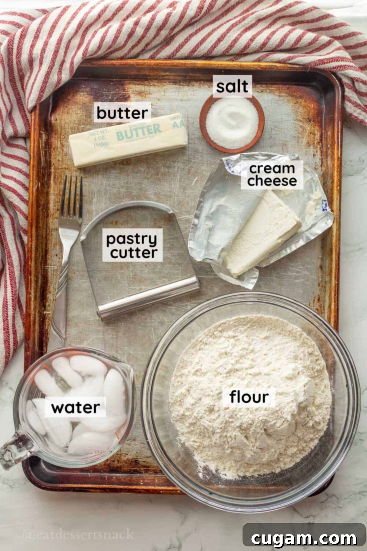 Labeled ingredients for cream cheese pie crust in glass bowls on metal pan.