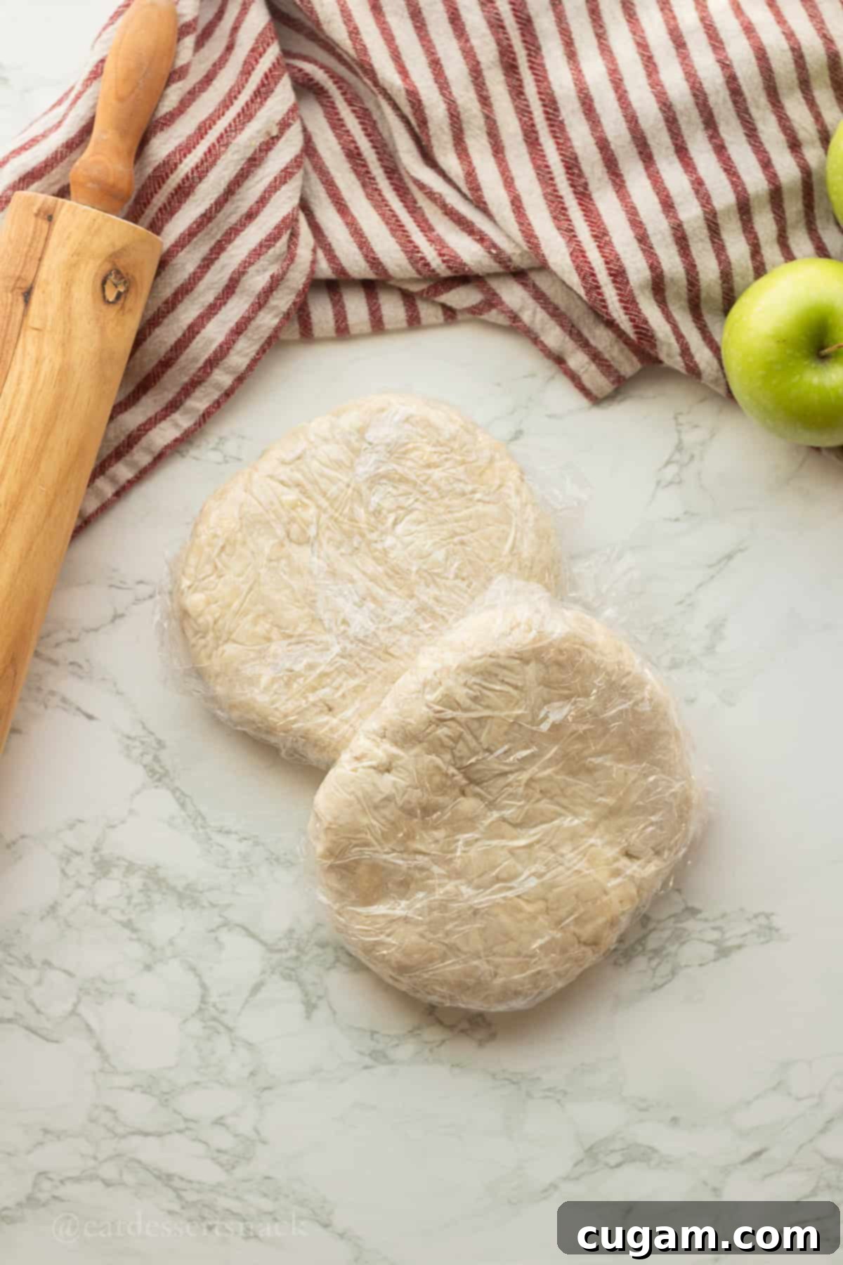 Plastic wrap around raw cream cheese pie dough.
