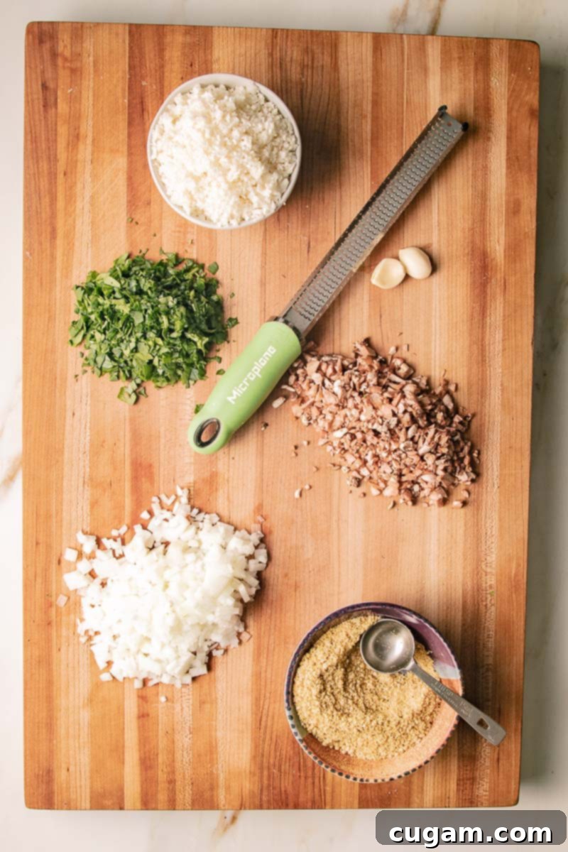 Prepped ingredients: chopped onions, greens, garlic, mushroom stems, cauliflower rice plus nuts and spcies.