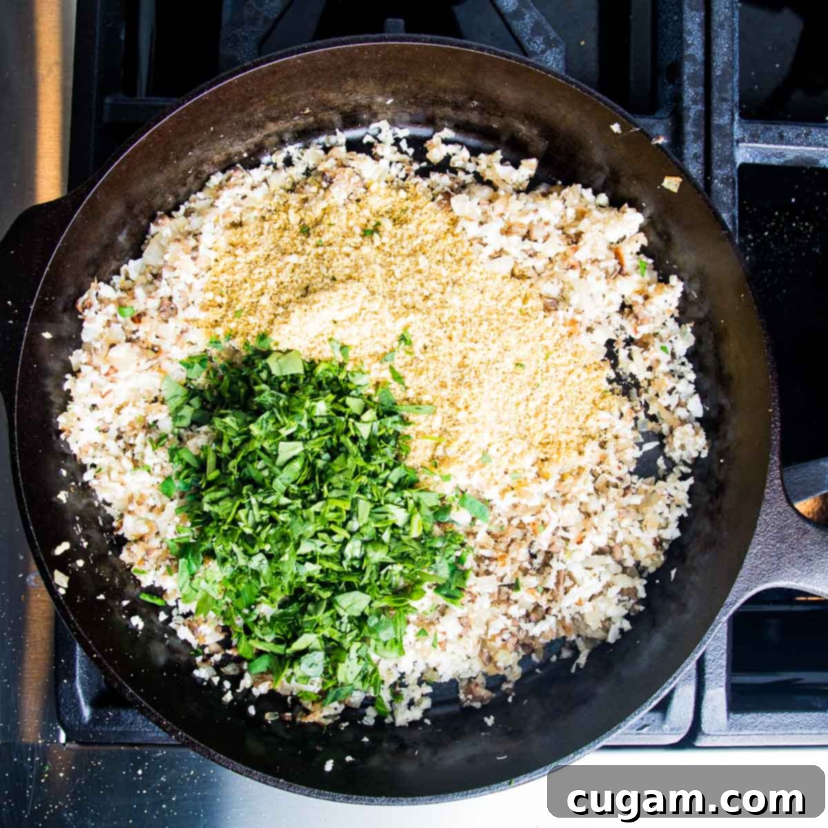 Chopped greens plus spices and nutritional yeast, cauli-rice added to sauteed onions.