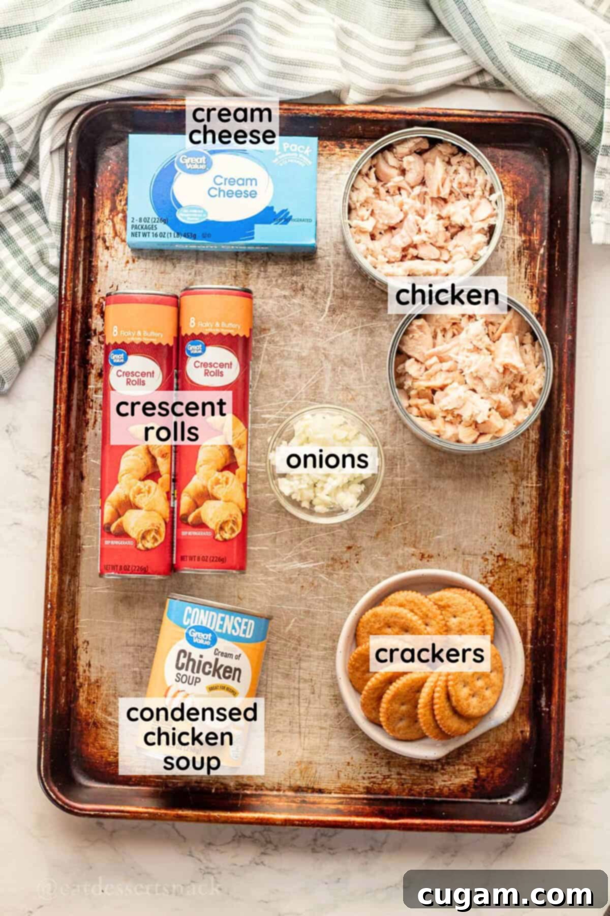 Labeled ingredients for chicken roll ups on metal pan in glass bowls.