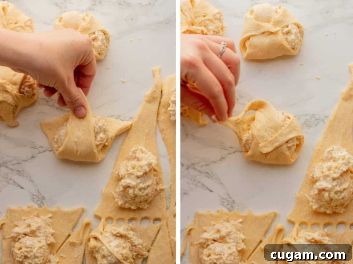 Rolling raw dough around chicken filling.