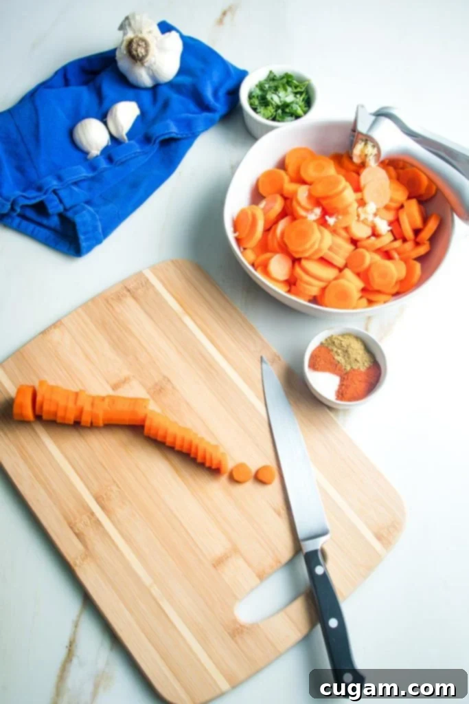 Slicing whole cooked carrots into perfect rounds on a cutting board.