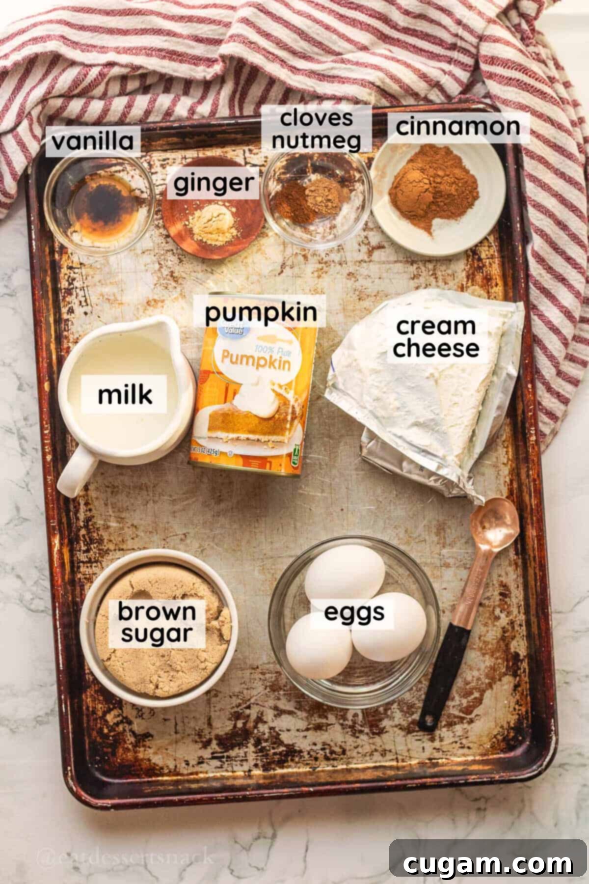 Labled Cream Cheese Pumpkin Pie ingredients in glass dishes on metal pan.