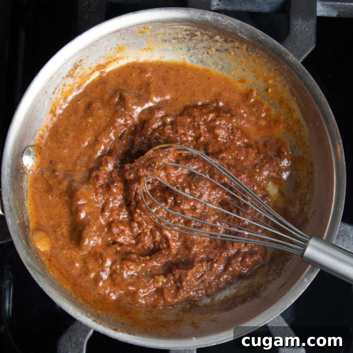Whisking in some veggie stock to the tomato and spice mixture. 