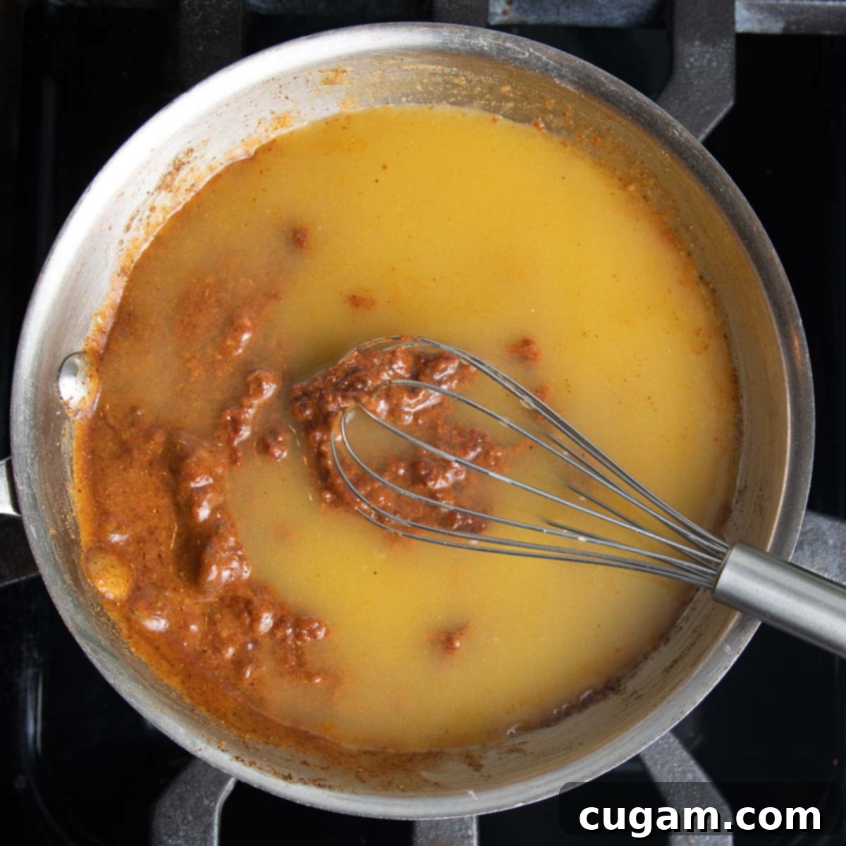Veggie Stock is added to tomato and spice mixture. 