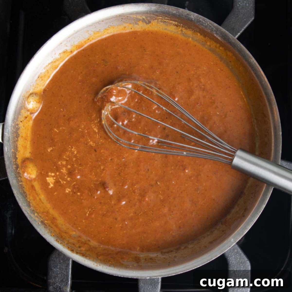 Whisking together homemade enchilada sauce. 