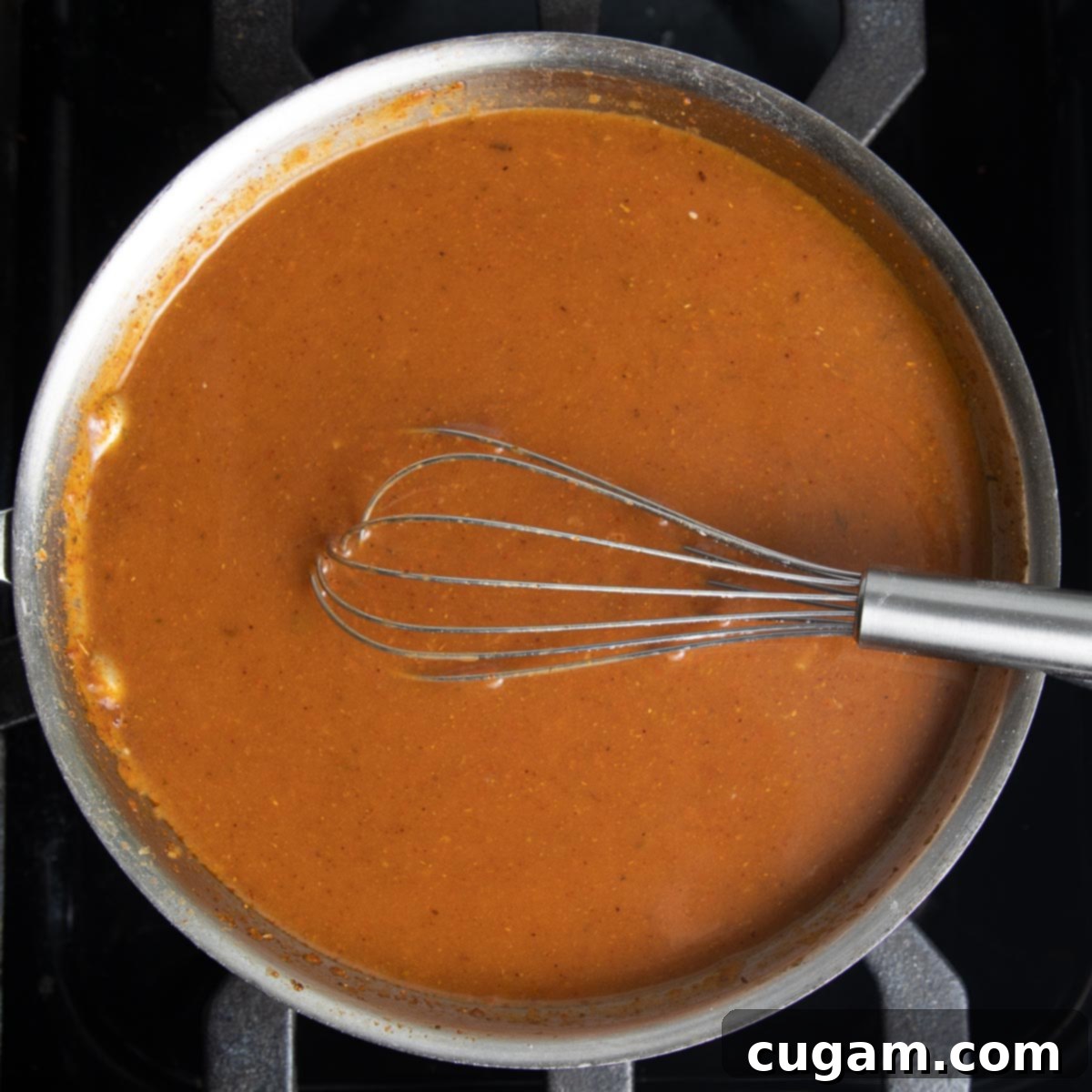 Homemade Red Enchilada Sauce thickening on the stove. 