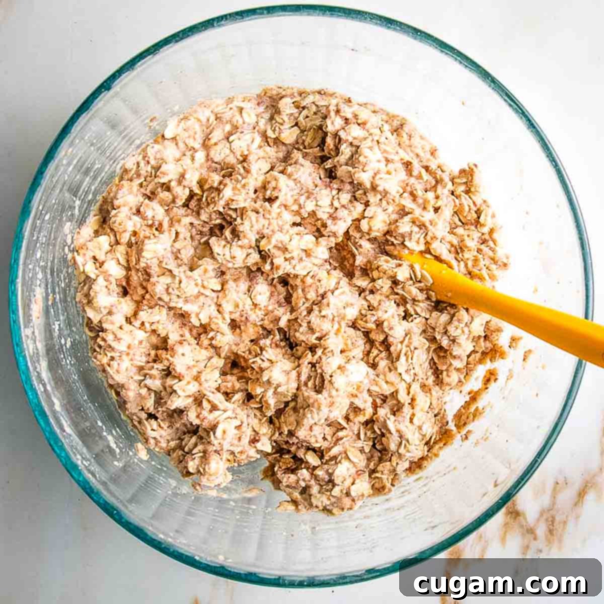 Mixing wet and dry ingredients together until just combined, ensuring spices are evenly dispersed.