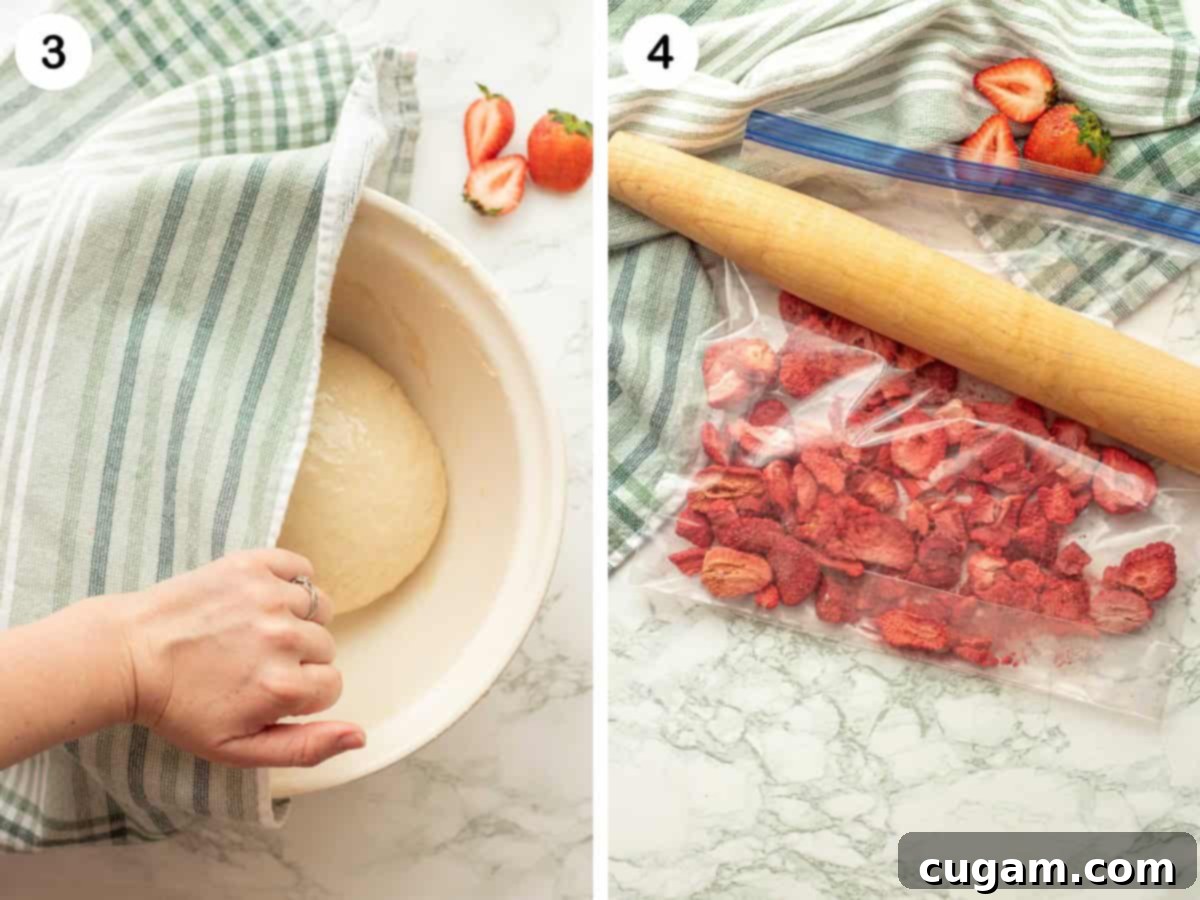 Raw cinnamon roll dough in bowl with towel and clear bag with strawberries and rolling pin.