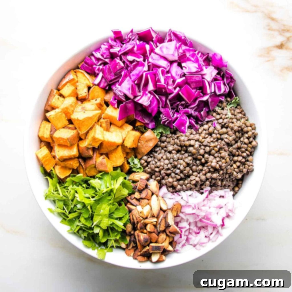 A visually appealing arrangement of colorful vegetables forming a wheel in a large bowl, emphasizing the salad's fresh and vibrant aesthetic.