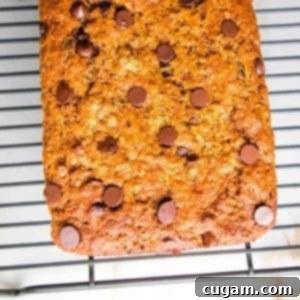 Chocolate Chip Zucchini Bread cooling on a wire rack on a white countertop.