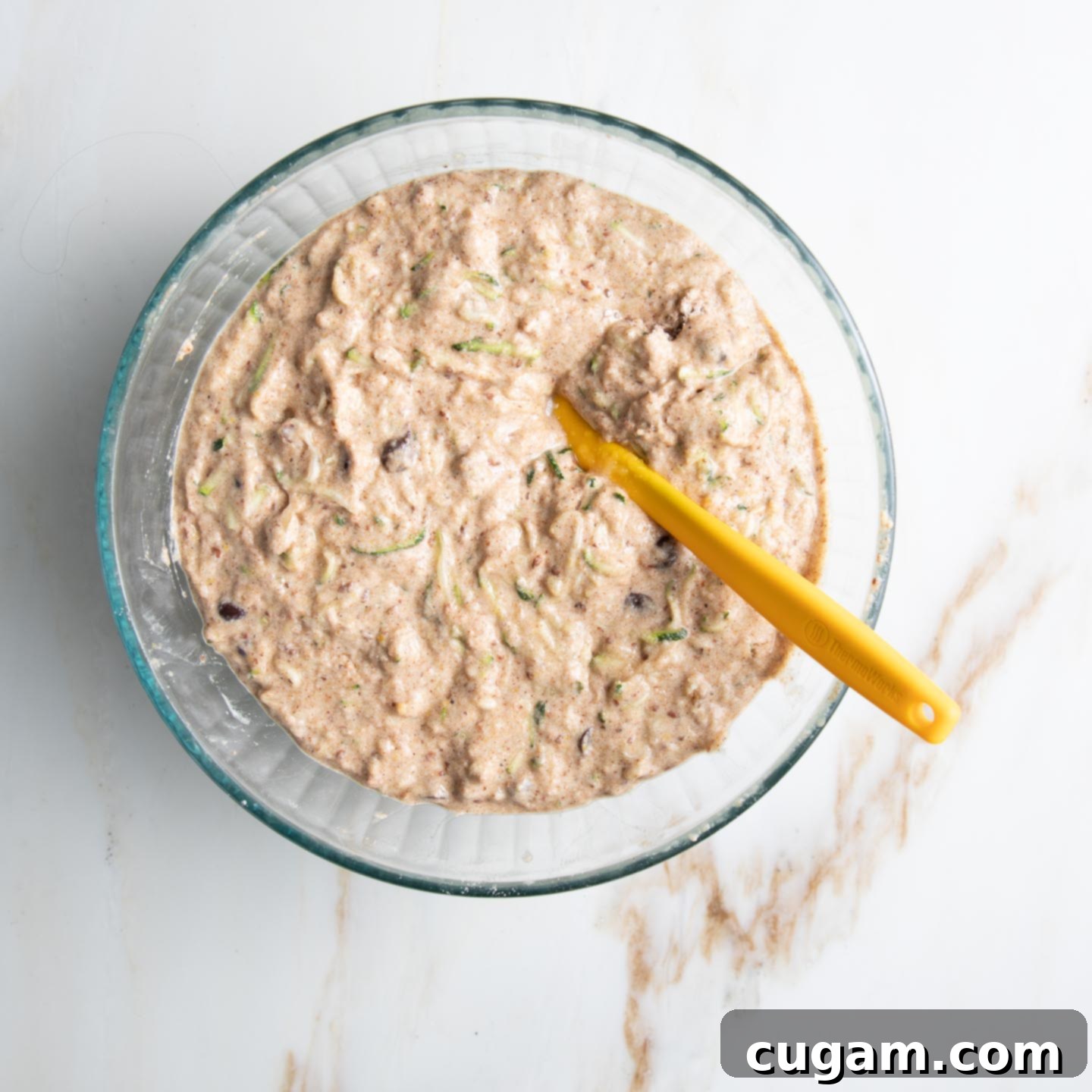 Zucchini bread batter in a bowl. 