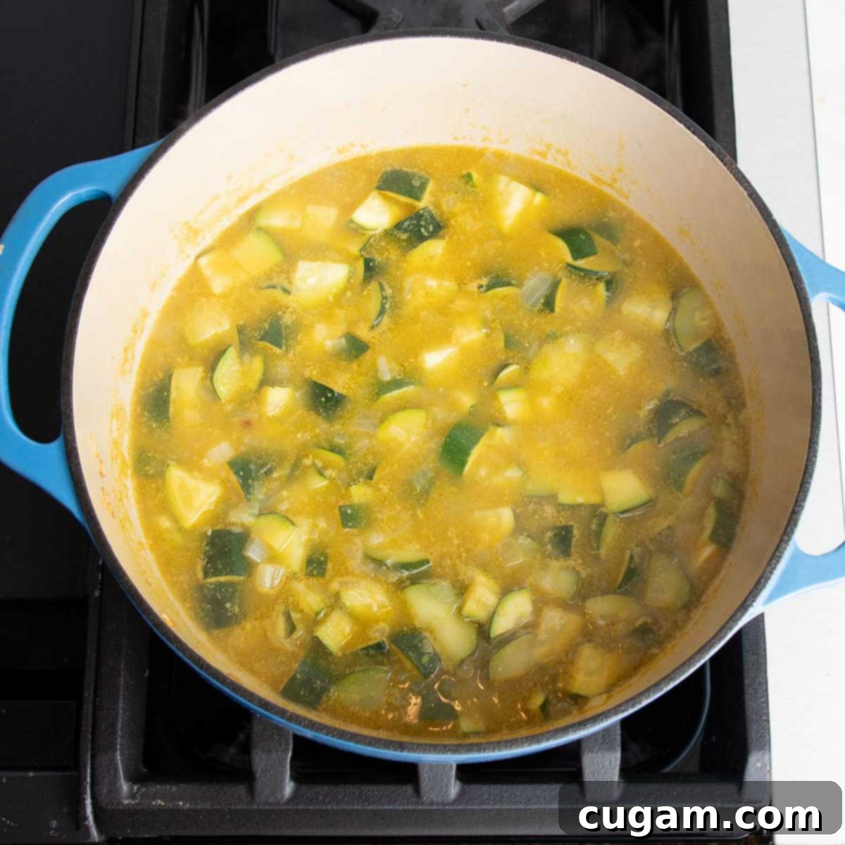 Easy Creamy Zucchini Soup 8 Zucchini, onions and garlic in a dutch oven with broth.