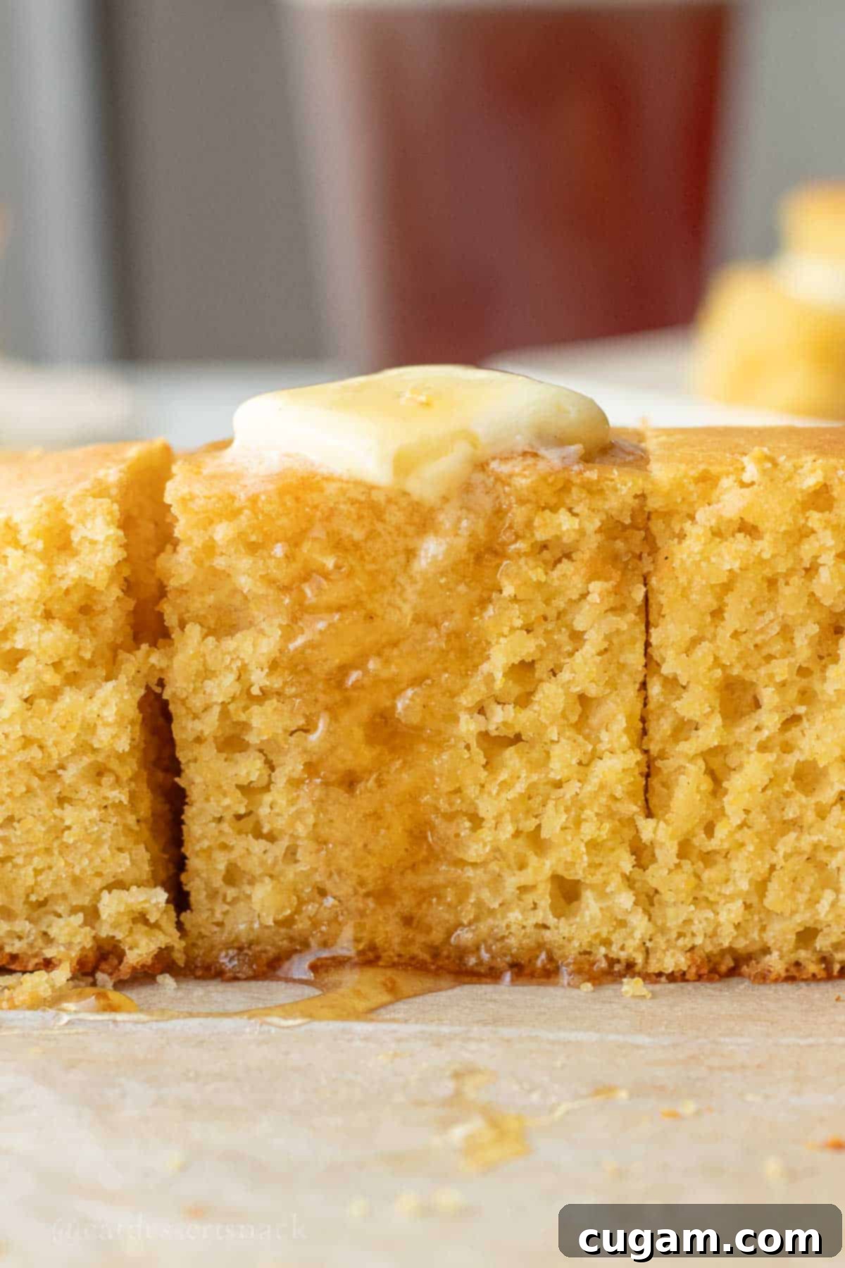 Drizzling honey over buttered cornbread slices, showcasing the golden crust and moist interior.