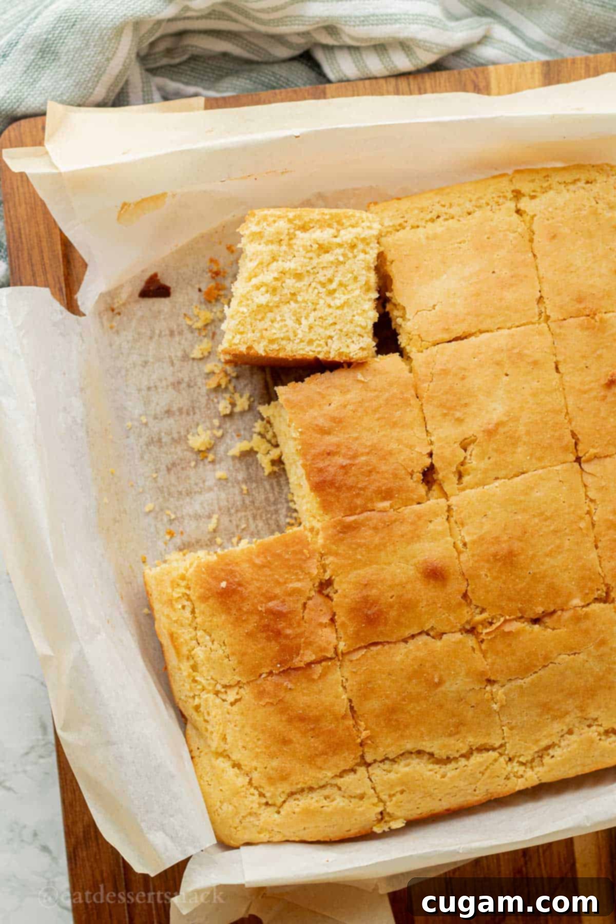 Perfectly sliced sourdough discard cornbread pieces resting on parchment paper, ready to serve.