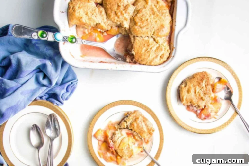 Serving peach cobbler from a baking dish to two plates. 