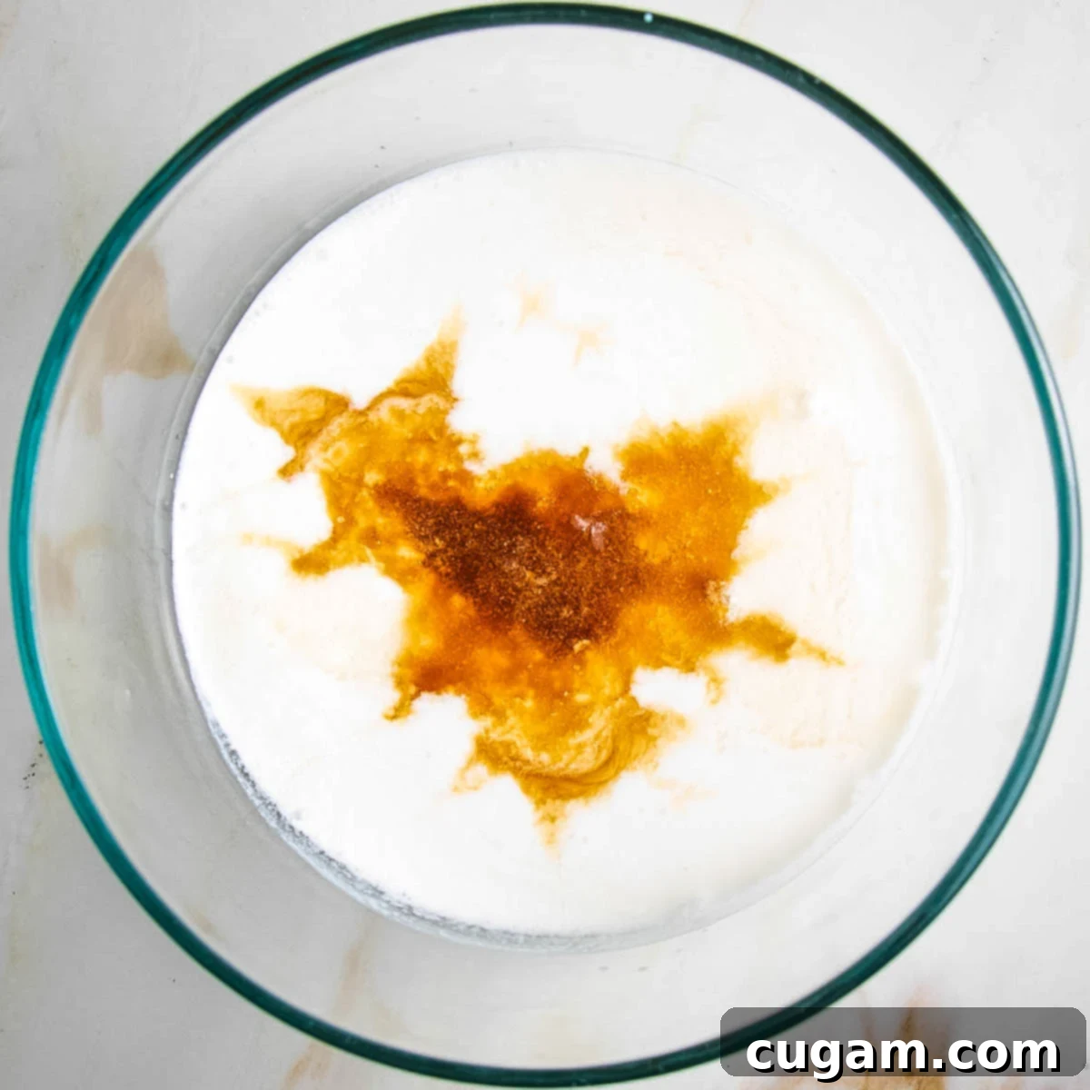 Almond milk, vanilla and other wet ingredients for fruit cobbler topping.