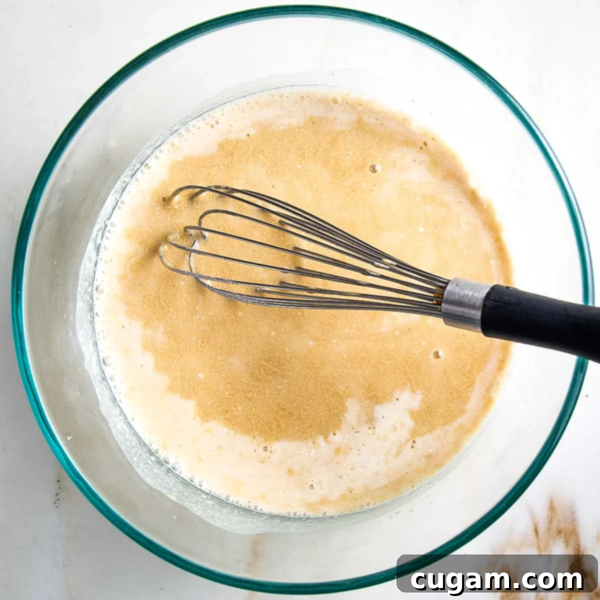 Whisking together wet ingredients for cobbler topping.