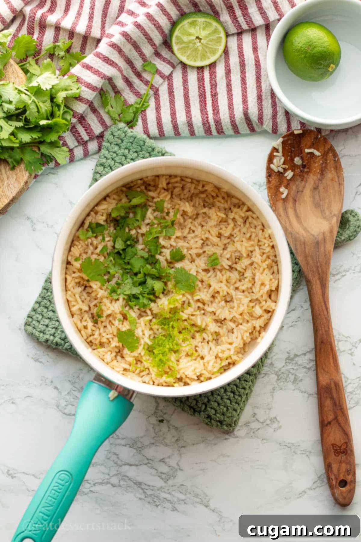 Adding cilantro and lime zest to pot of cooked rice.