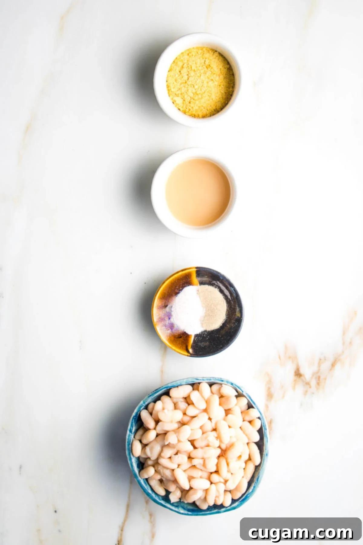 Delicious Vegan Mexican Street Corn 6 Vegan cotija cheese ingredients: white beans, lemon juice, spices, nutritional yeast, laid out on a board.