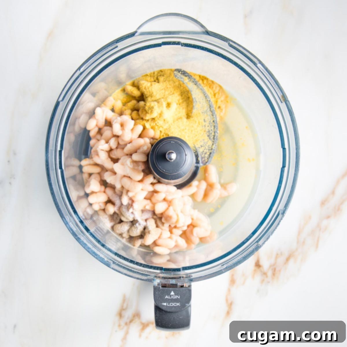 Delicious Vegan Mexican Street Corn 7 Food processor bowl with white beans, lemon juice and spices, ready for blending.