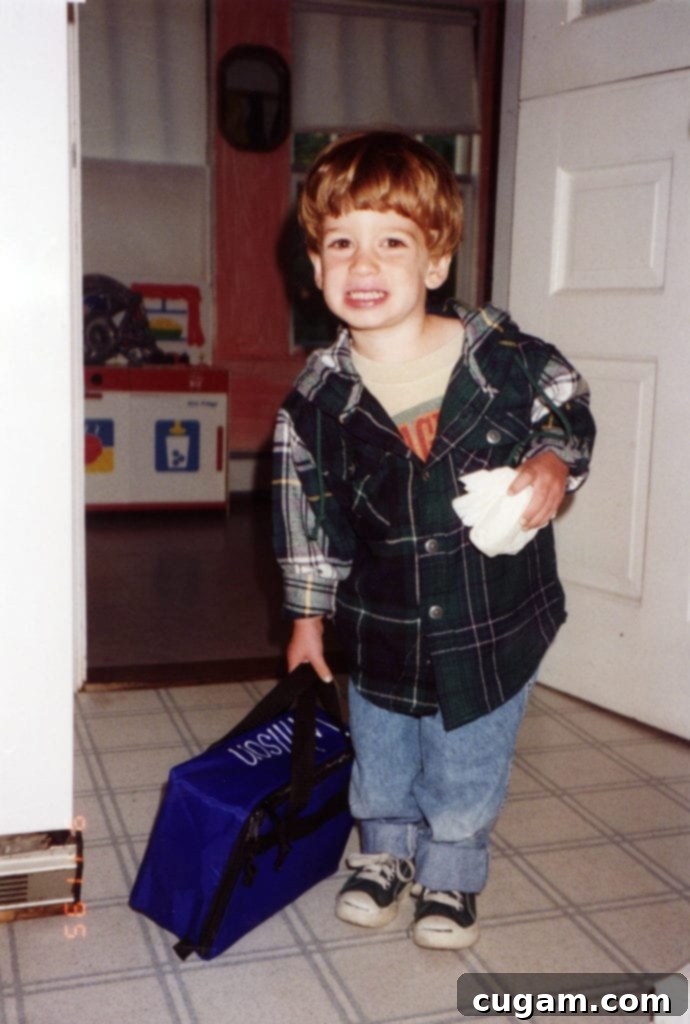 A little boy with a lunch box.