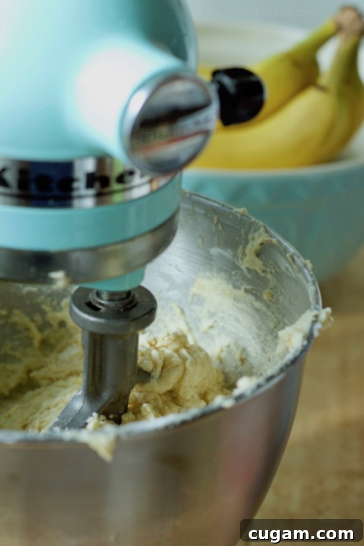 Banana Coffee Cake batter in a blue stand mixer. 