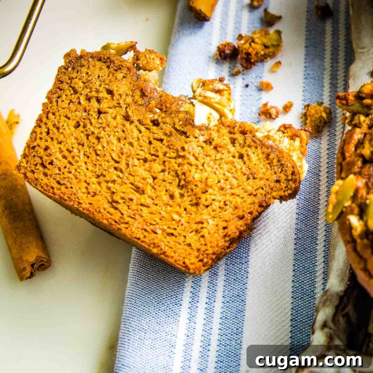 Pumpkin muffin cut in half so the inside texture is seen.