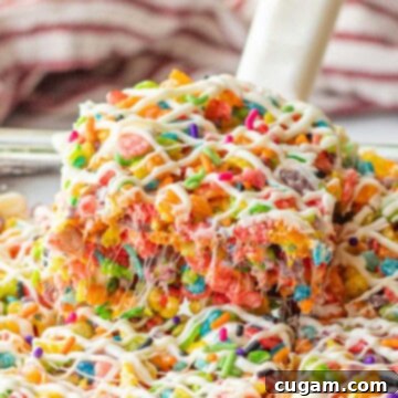 Spatula with slice of fruity pebble rice crispy treat.