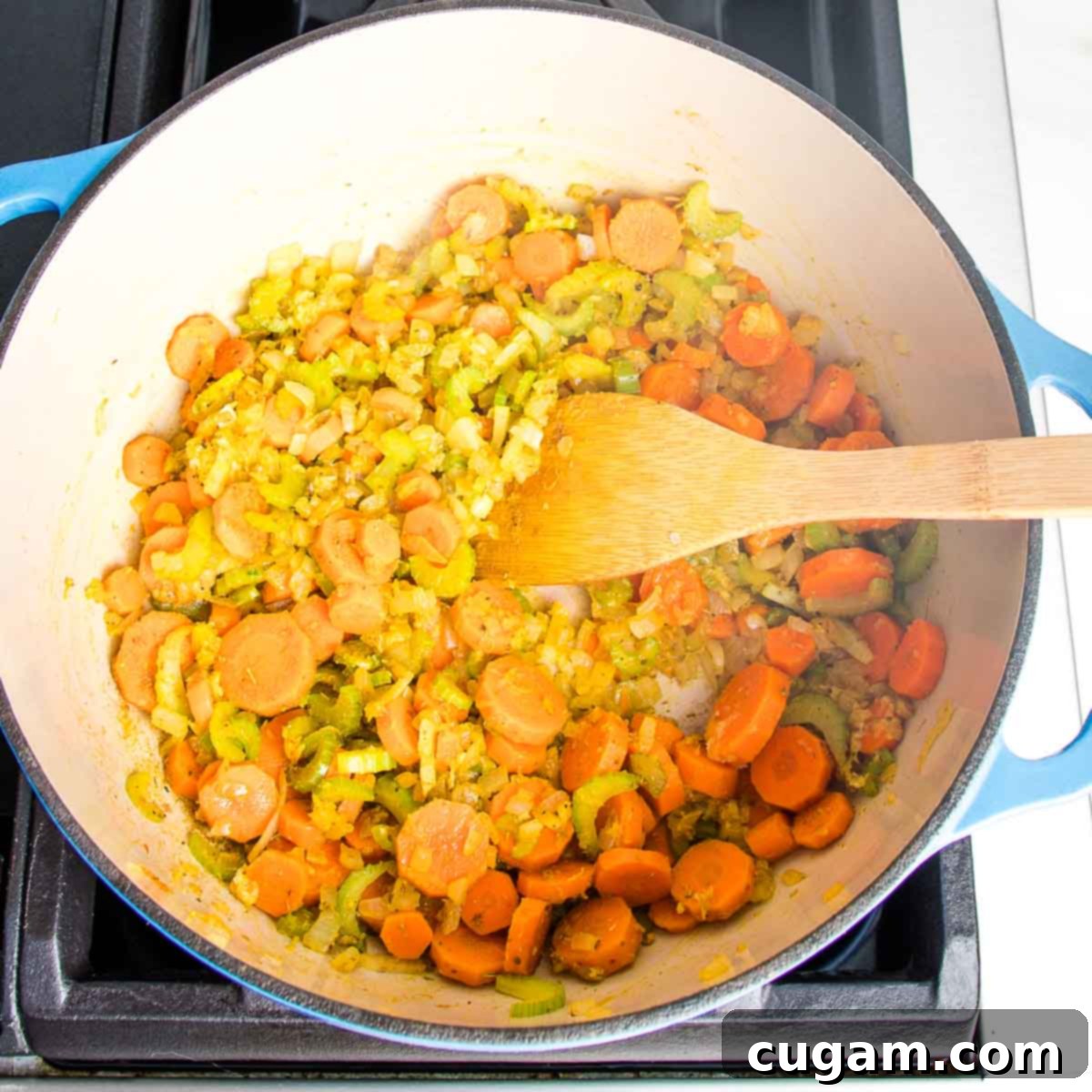Nourishing Vegan Lemon Chickpea Rice Soup 7 Dutch oven with sautéed carrots, onions, celery, spices, and garlic, waiting for the rice.