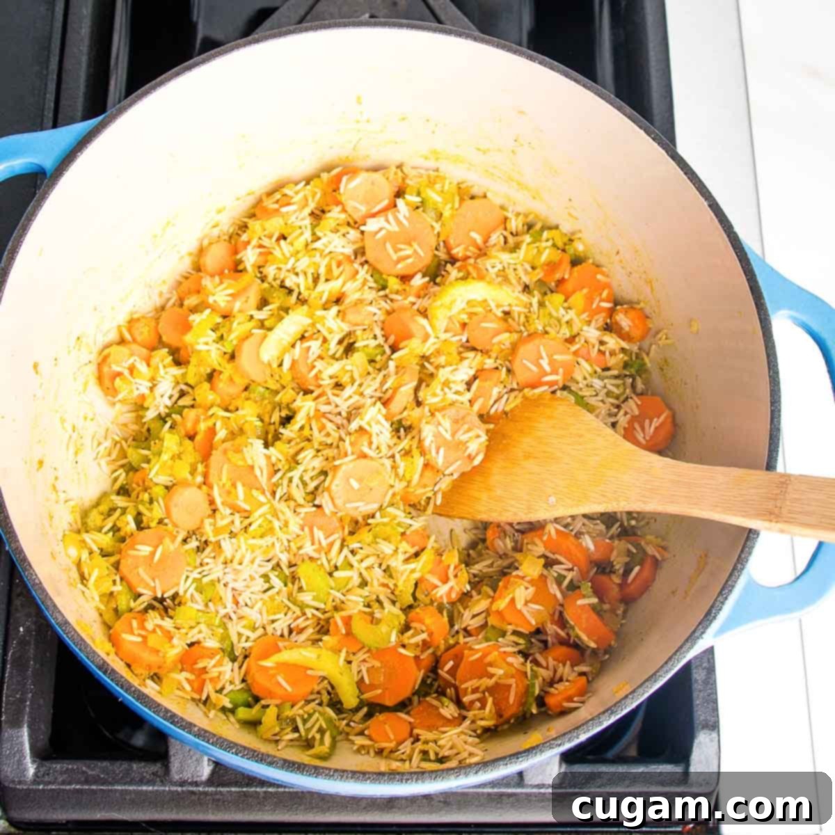 Nourishing Vegan Lemon Chickpea Rice Soup 8 Sauteed vegetables and spices mixed with rice, coating each grain with flavor.