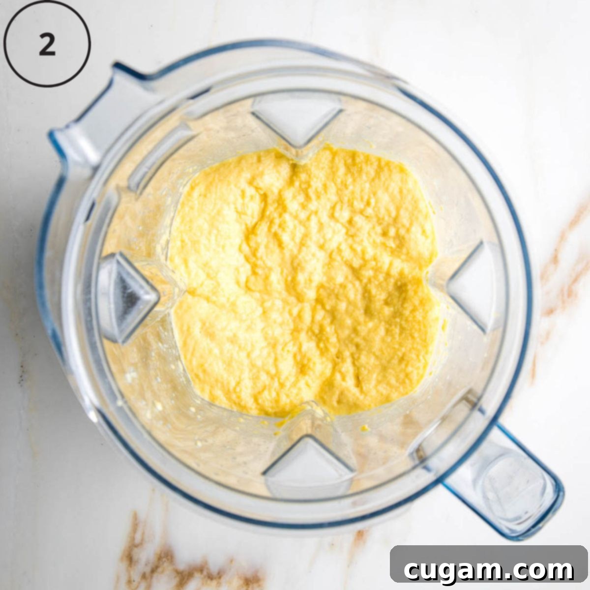 Gluten-Free Vegan Double Corn Cornbread 5 The blender now contains a thick, creamy, pale yellow mushy corn mixture, indicating it's been thoroughly processed.
