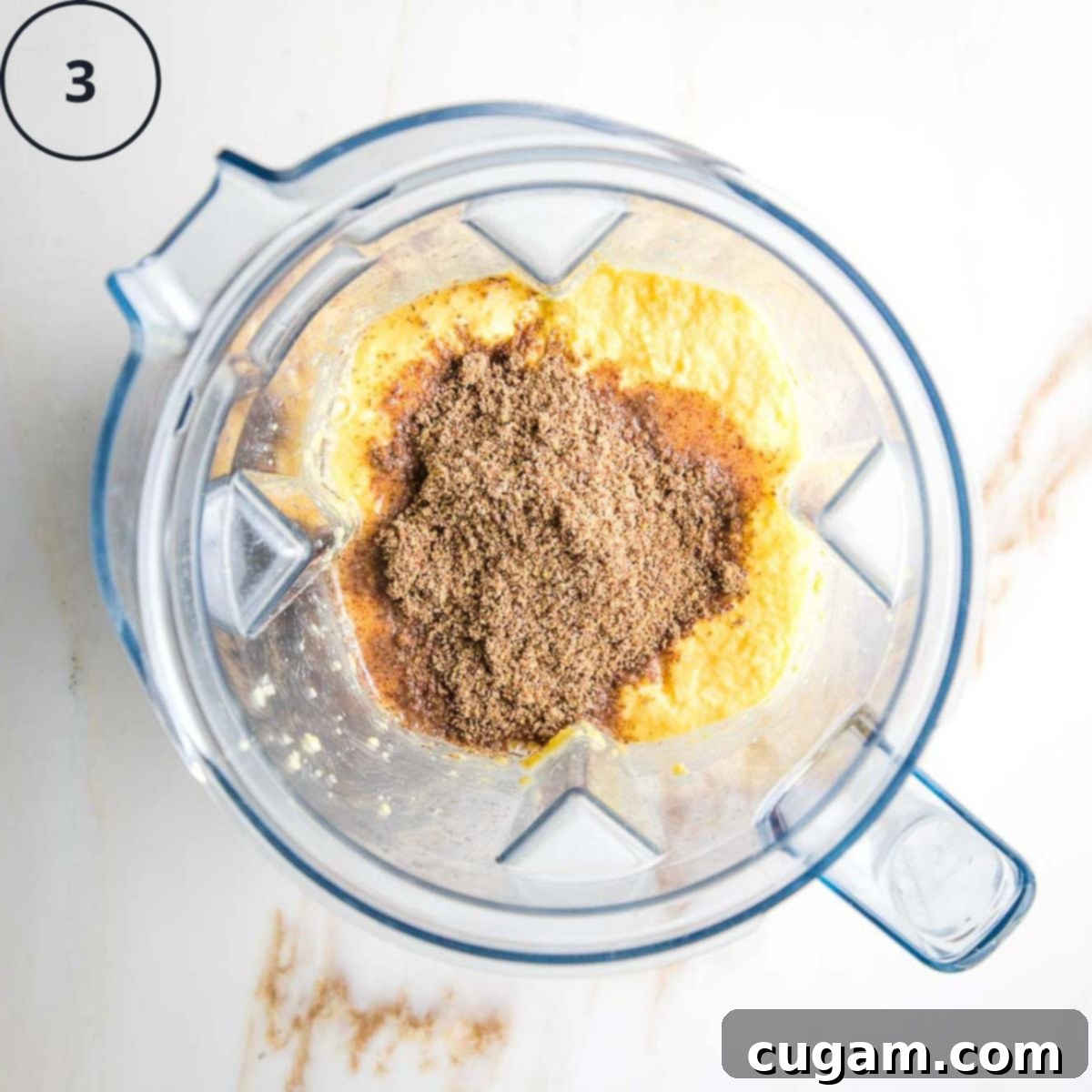 Gluten-Free Vegan Double Corn Cornbread 6 The blender now contains the mushy corn mixture, with additional ingredients like ground flaxseed and maple syrup added on top, ready for further blending.