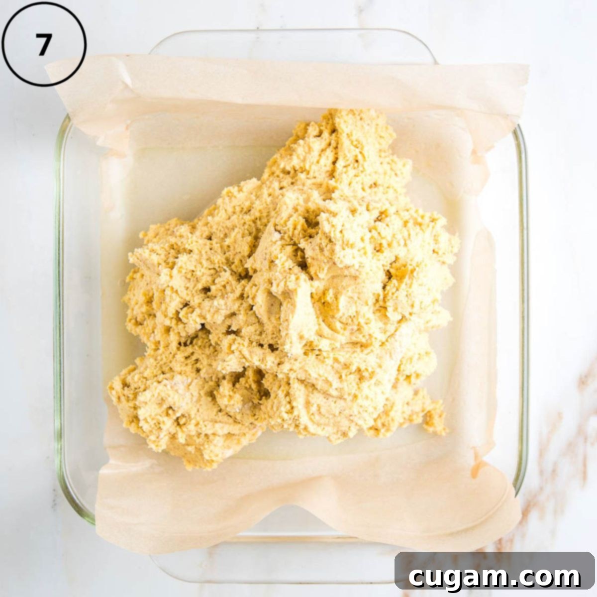 Gluten-Free Vegan Double Corn Cornbread 10 The thick cornbread batter has been neatly dumped into a square baking pan, which is lined with unbleached parchment paper, ready for smoothing.