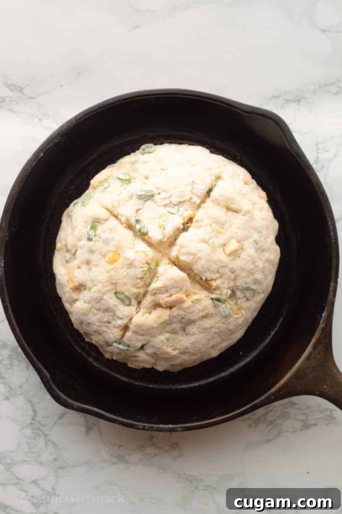 Cut raw irish soda bread in cast iron pan.