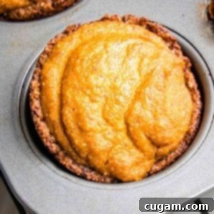 Close up of a mini pumpkin pie in a muffin tin.