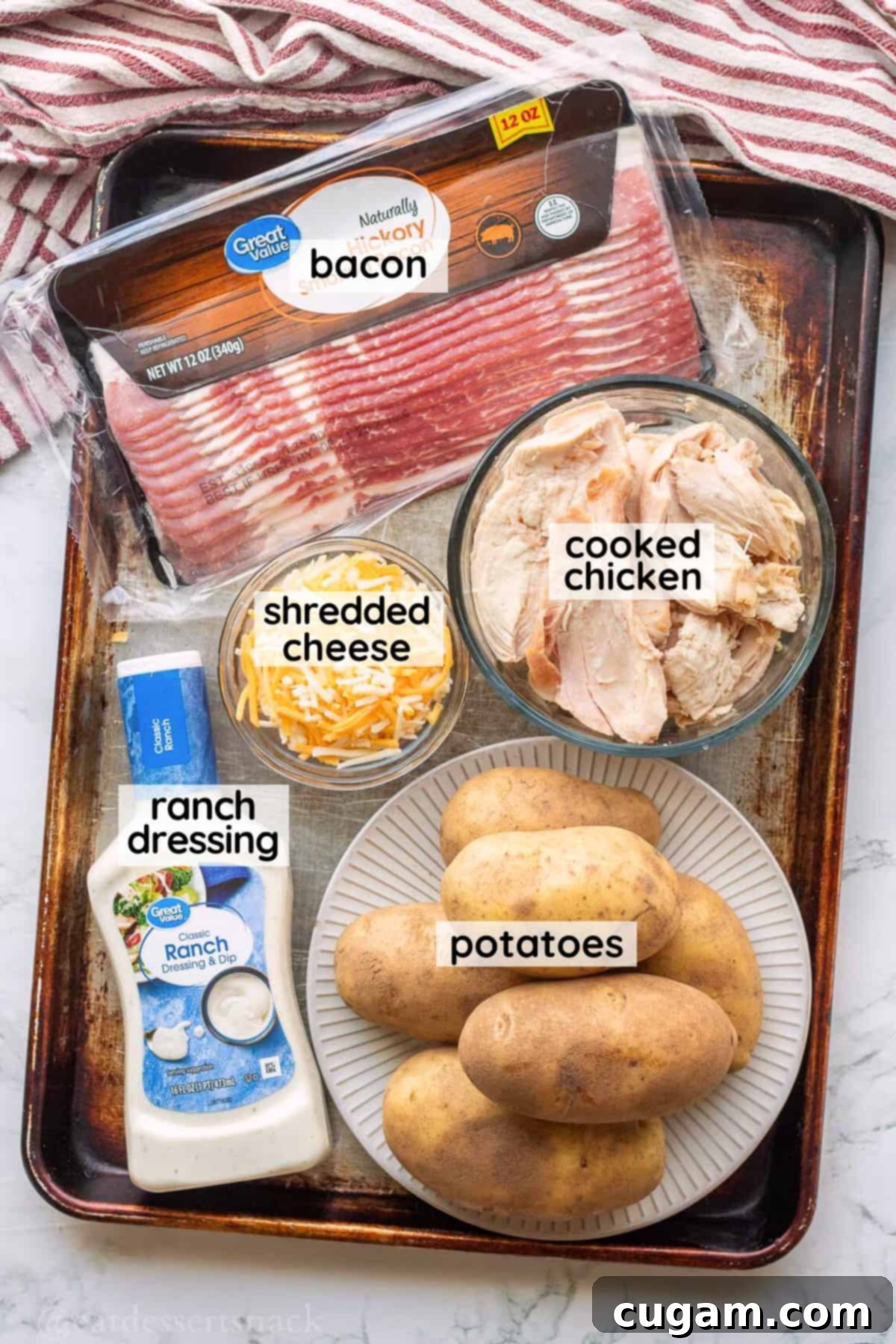 Chicken Bacon Ranch Baked Potatoes 3 Labeled ingredients for chicken bacon ranch baked potatoes neatly arranged on a metal baking sheet in glass bowls.