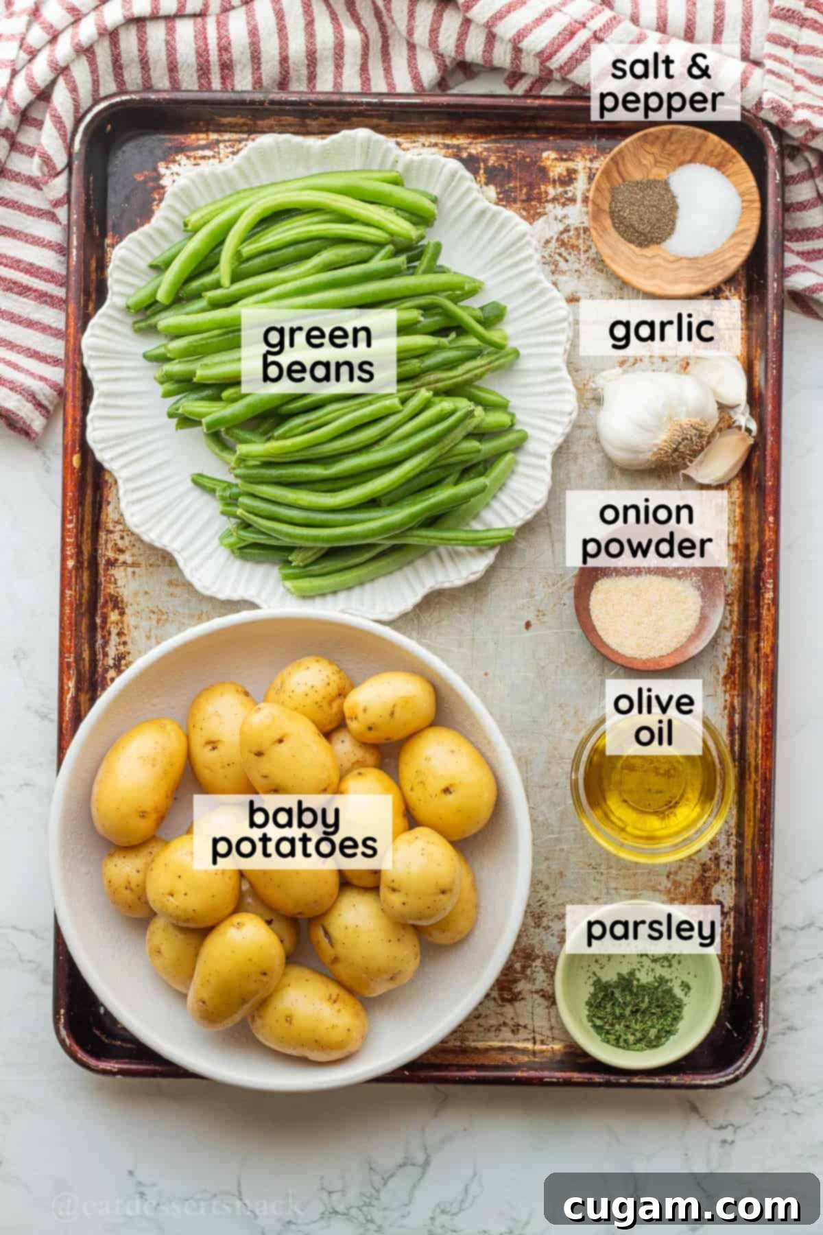 Labeled ingredients for green beans and potatoes on metal baking sheet.