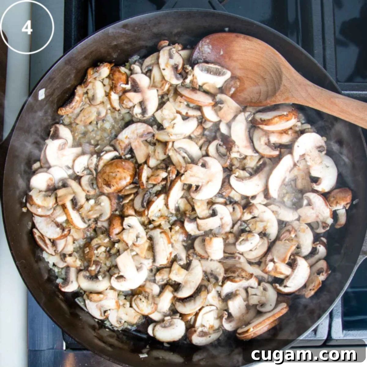 Cast iron skillet containing beautifully sautéed mushrooms and onions, beginning to brown and release their moisture.