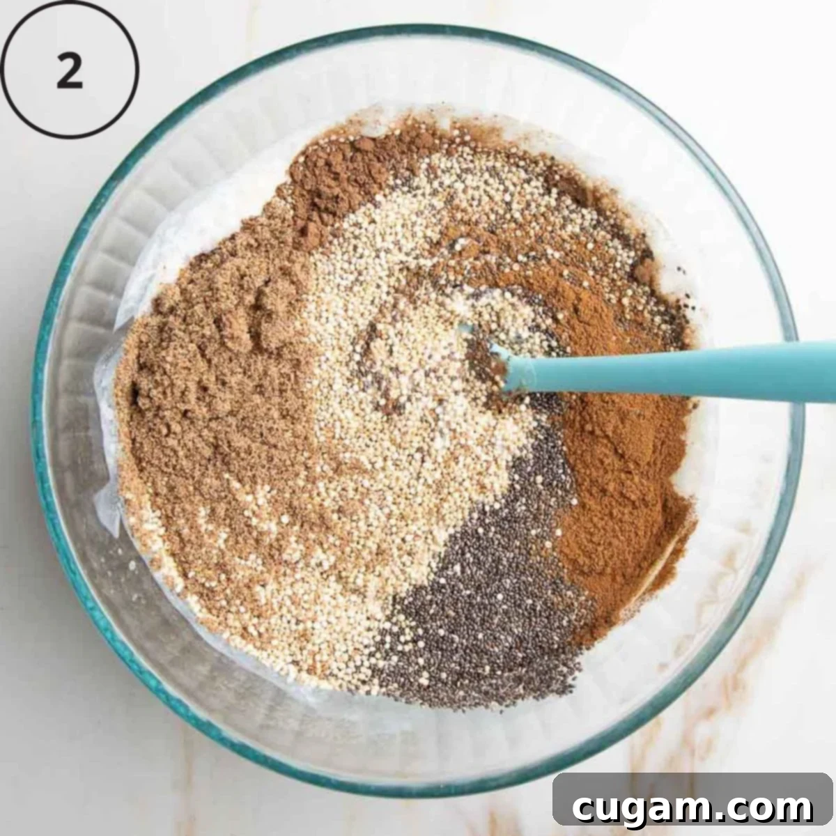 Earthy-toned dry ingredients, including raw quinoa, ground flaxseed, chia seeds, and spices, being gently mixed into the previously prepared wet ingredients in a large glass bowl, creating a textured batter.