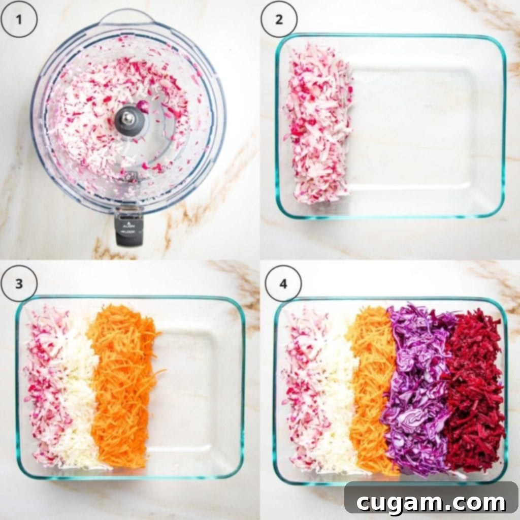 Assorted shredded vegetables neatly organized in a glass meal prep container, ready for assembly.