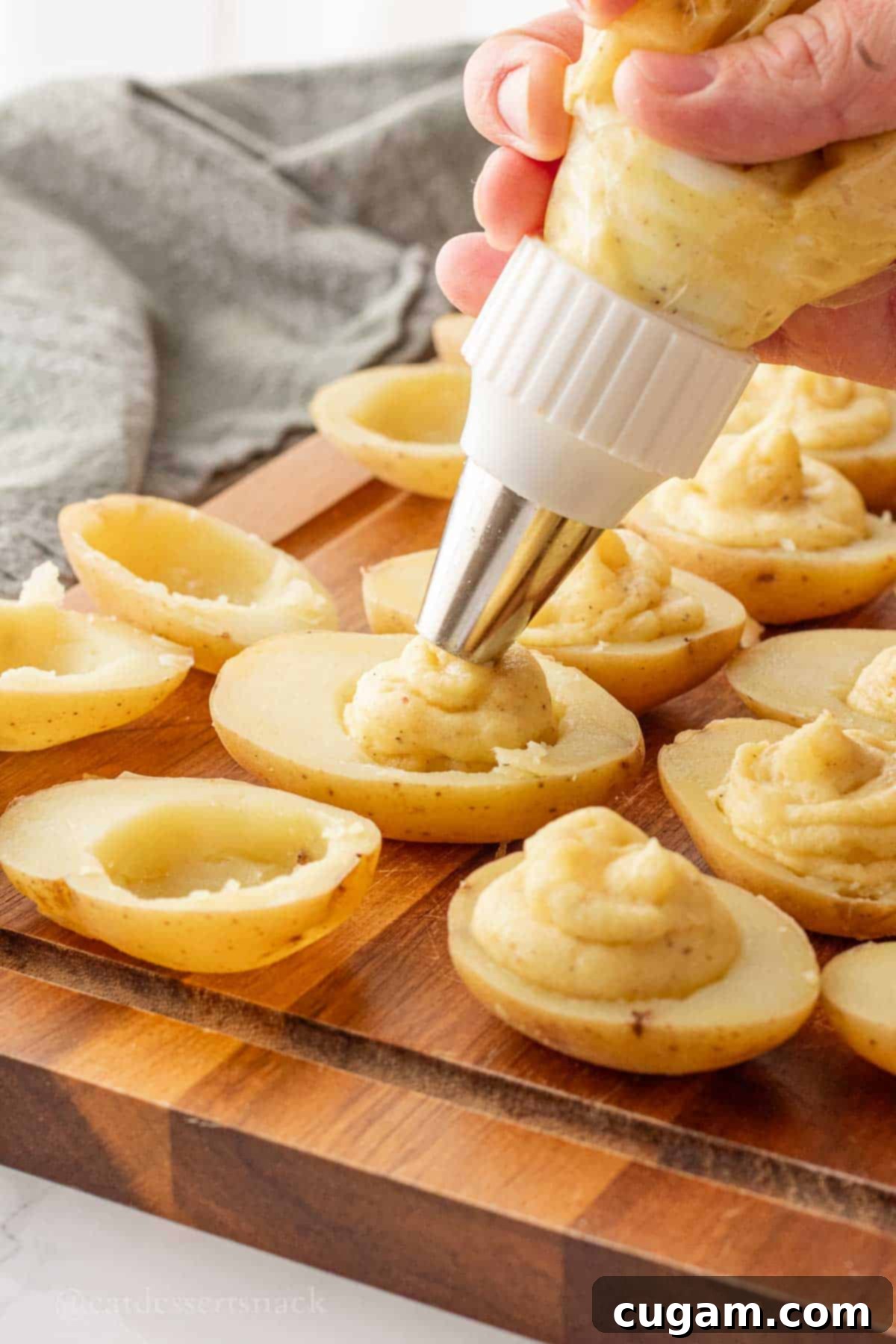 Filling potatoes with pastry tip.