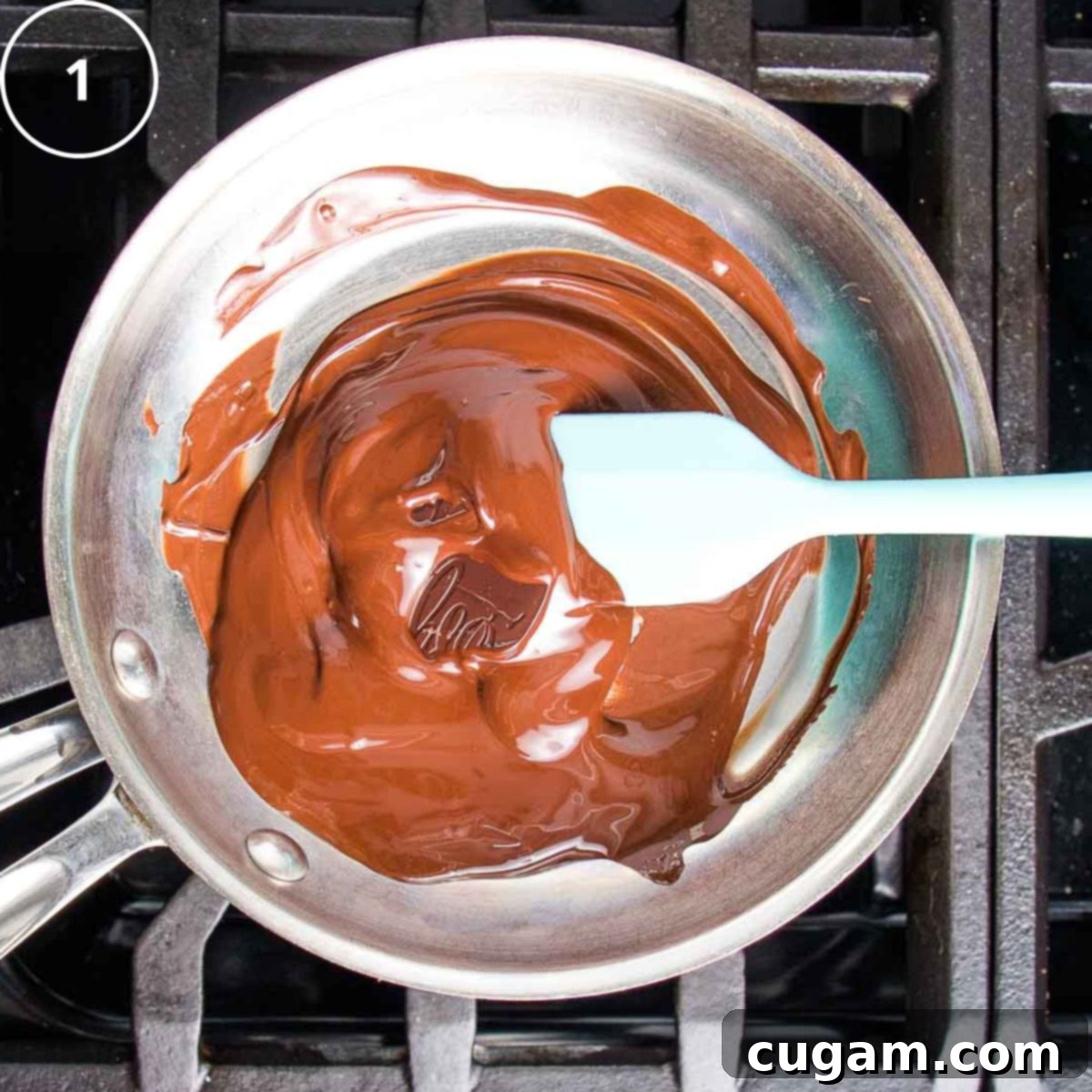 Squares of dark chocolate melting in a small pan on top of simmering water.