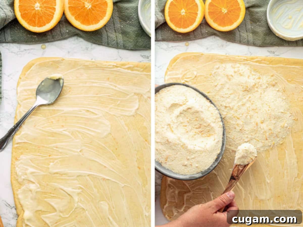 Spreading butter over rolled out orange roll dough then sprinkling orange zest and sugar over butter and raw orange dough.