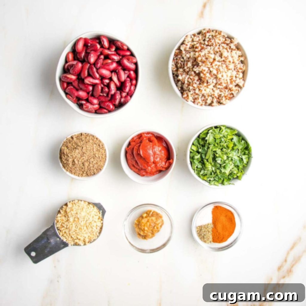 Selection of fresh ingredients for quinoa veggie burgers: quinoa, kidney beans, fresh parsley, tomato paste, flaxseed, smoked paprika, miso paste, and walnuts.