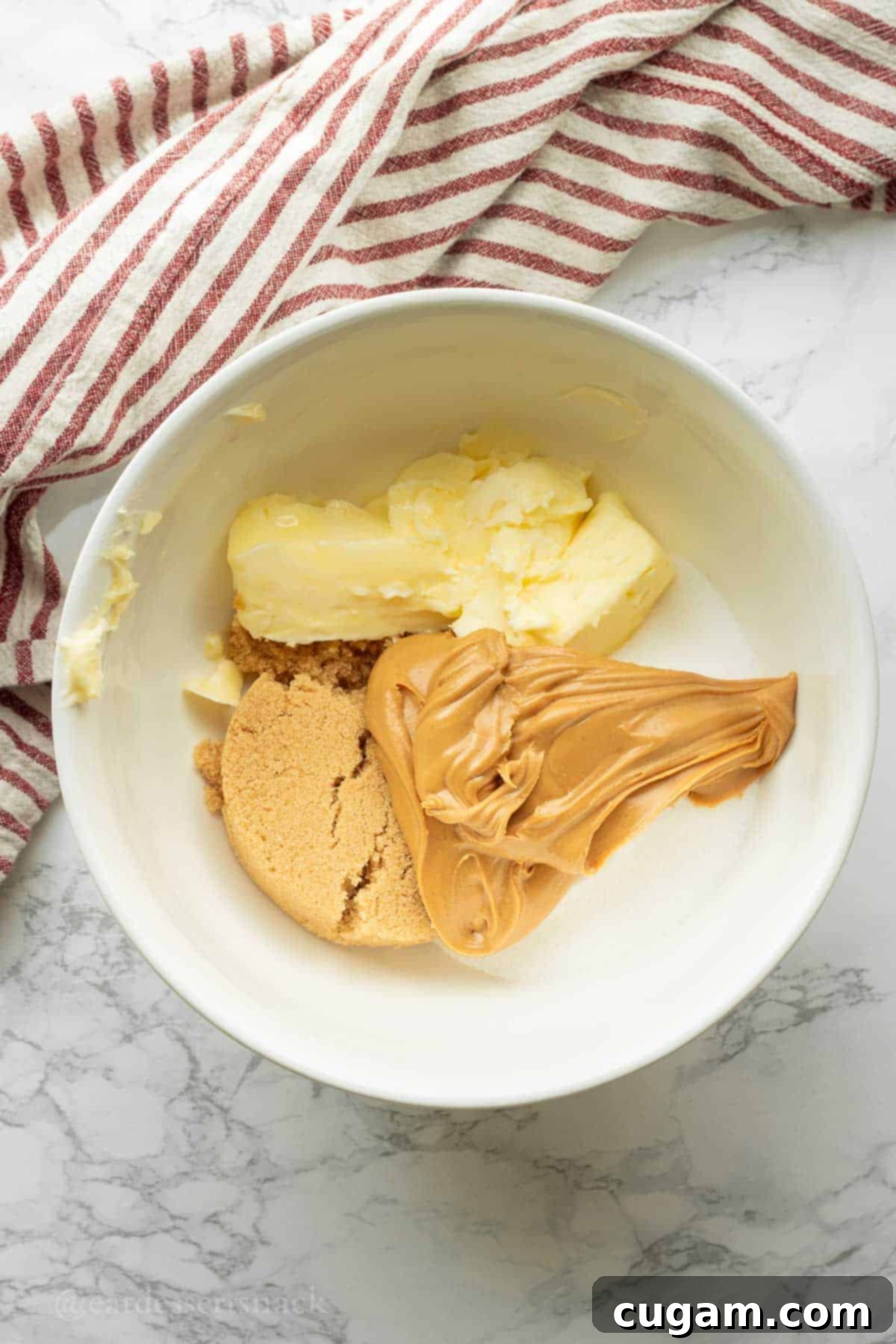 Peanut butter, sugar, and butter in a bowl.
