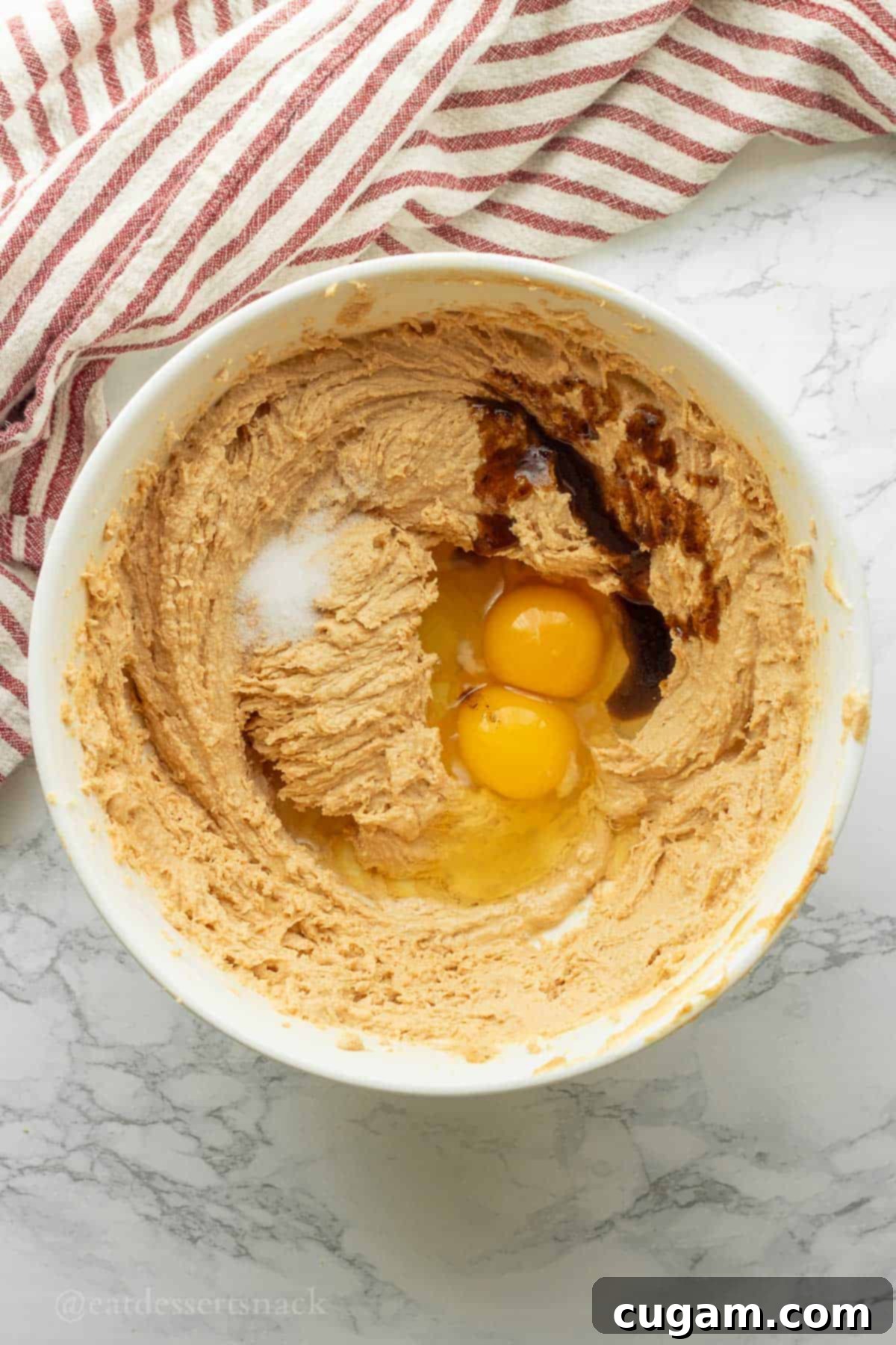 Eggs, salt, and vanilla in bowl with butter and sugar.