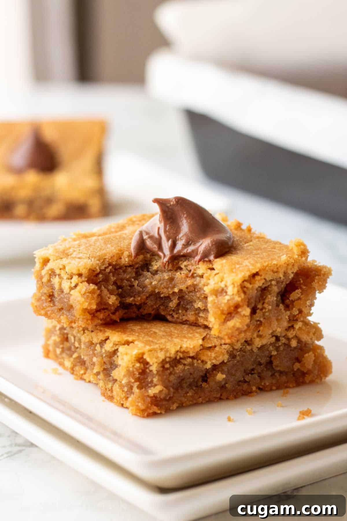 Bite from peanut butter blossom bar on plate.