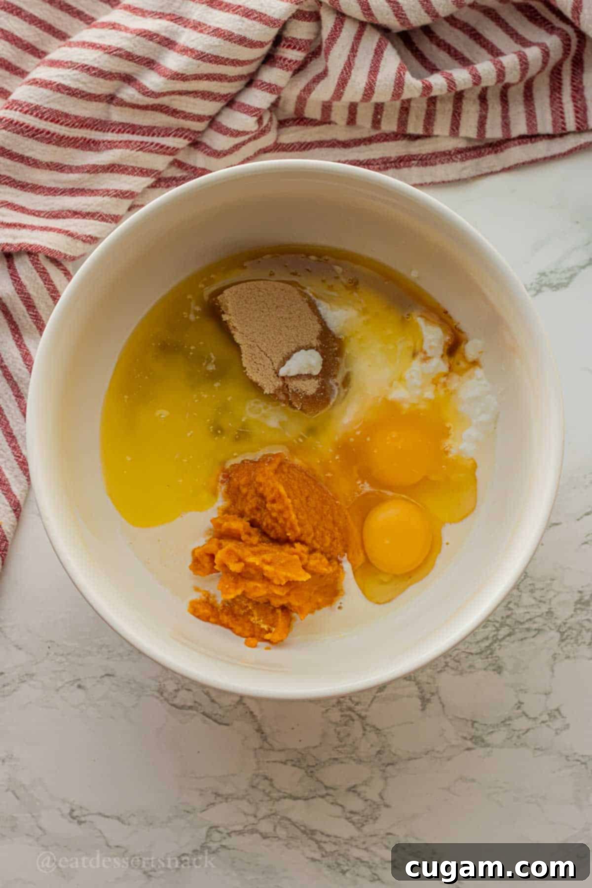 Pumpkin, eggs, sour cream, brown sugar, and vanilla in mixing bowl.
